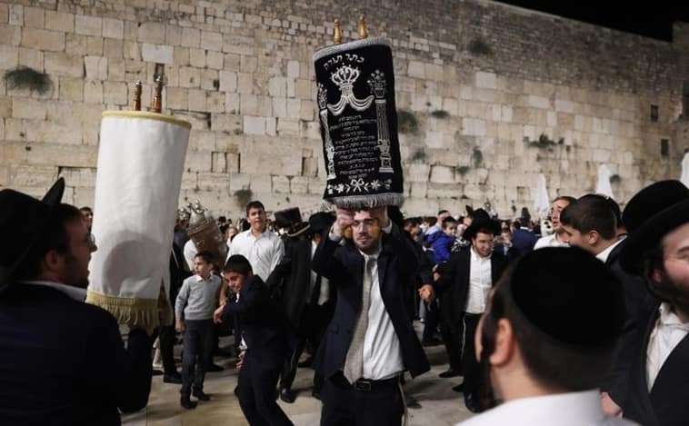 Ultra-Orthodox Jews dance with Torah scrolls during Simchat Torah celebrations at the end of the Sukkot holiday at the Western Wall in Jerusalem's Old City